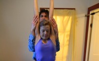 This photo demonstrates Roger Baril with one of his clients doing somatic movement re-education. Range of motion in a standing position with the shoulder girdle and thoracic spine and trunk. The latisimus dorsi muscles are released in the process. Helps release upper back and shoulder pain.